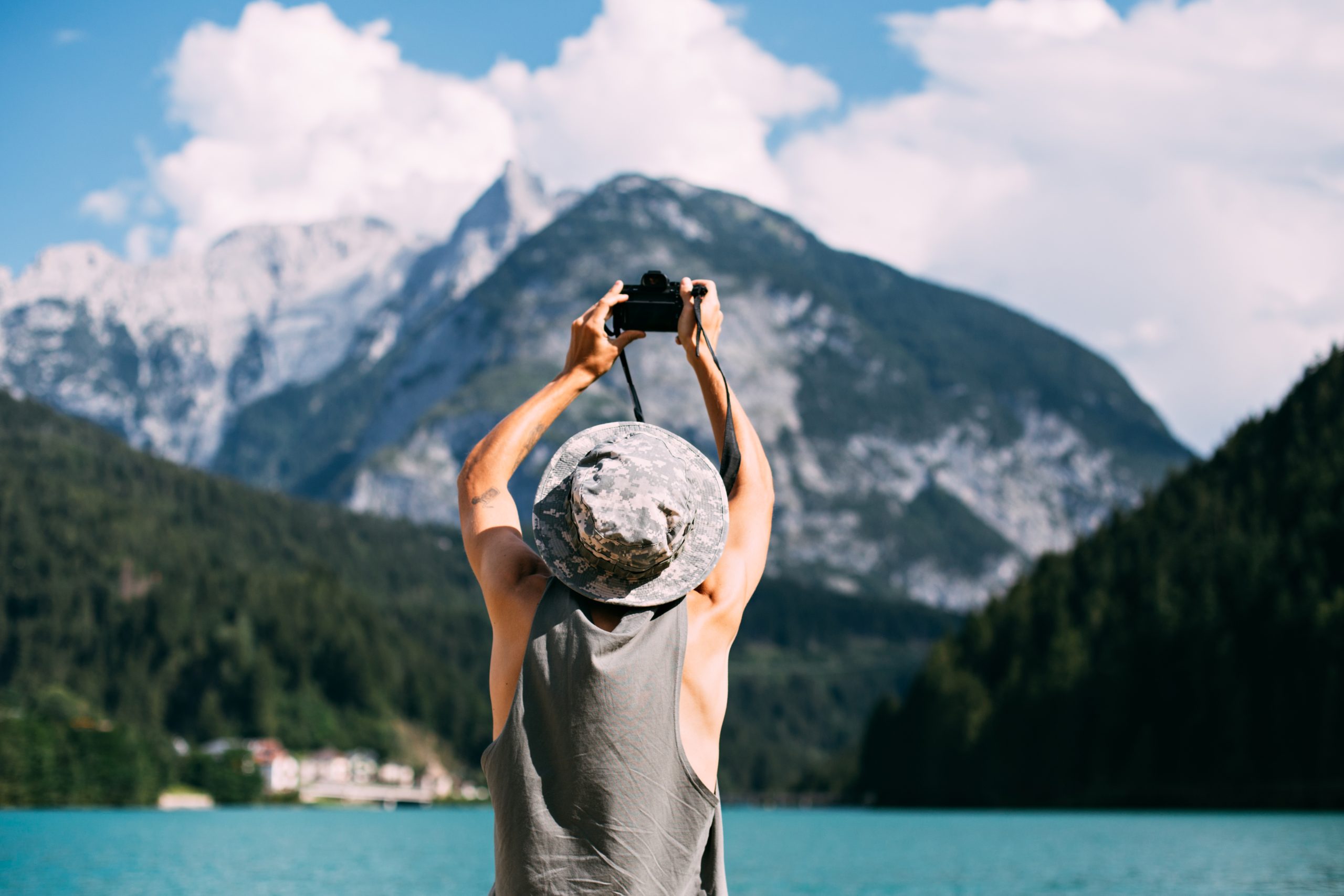 Hiking Tourist Taking Photos Using His Hi-End Smartphone Device. Travel Concept. Mountain Hiker.